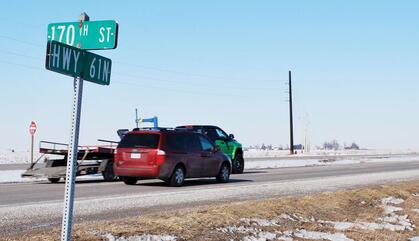 Cars drive by on a winter day on Highway 61 in Muscatine, IA