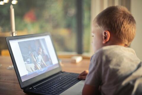 Young boy watching video on a laptop