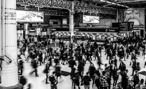 A black-and-white photo of a bustling train station
