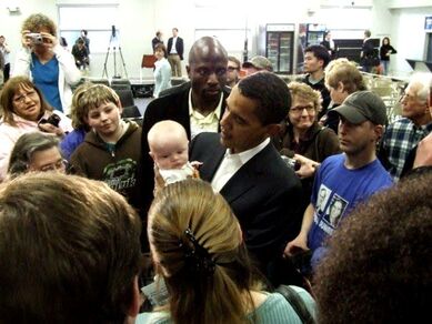 Senator Barack Obama holds a baby during a campaign event in 2007